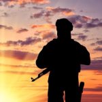 concept-terrorism-silhouette-terrorist-with-weapon-against-background-sunset_556258-1920