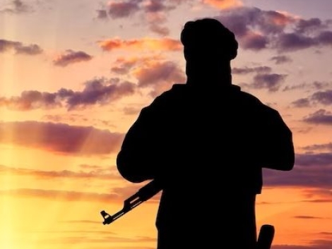 concept-terrorism-silhouette-terrorist-with-weapon-against-background-sunset_556258-1920